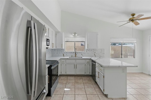 9116 Cypress Point Way, Las Vegas, NV 89117 - kitchen with stainless steel appliances, a peninsula, a sink, ceiling fan, and backsplash