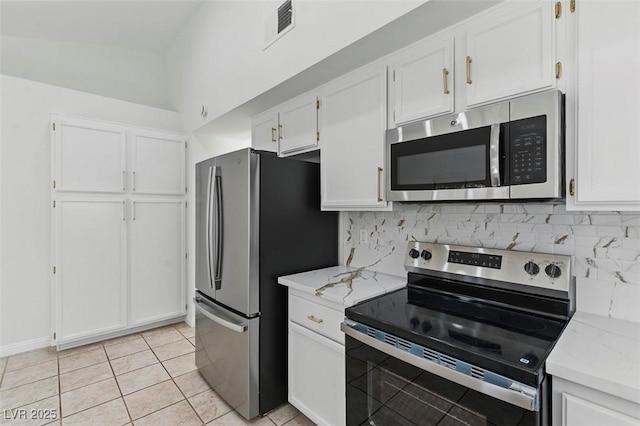 9116 Cypress Point Way, Las Vegas, NV 89117 - kitchen with stainless steel appliances, tasteful backsplash, white cabinets, and light stone counters
