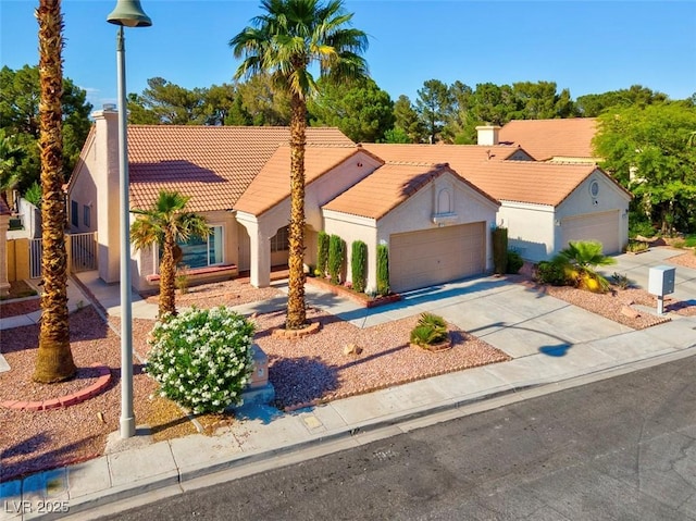 9116 Cypress Point Way, Las Vegas, NV 89117 - mediterranean / spanish home with a tile roof, stucco siding, an attached garage, and driveway