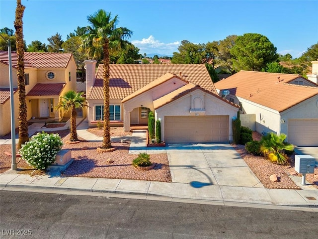 9116 Cypress Point Way, Las Vegas, NV 89117 - mediterranean / spanish house featuring a tile roof, stucco siding, an attached garage, and concrete driveway