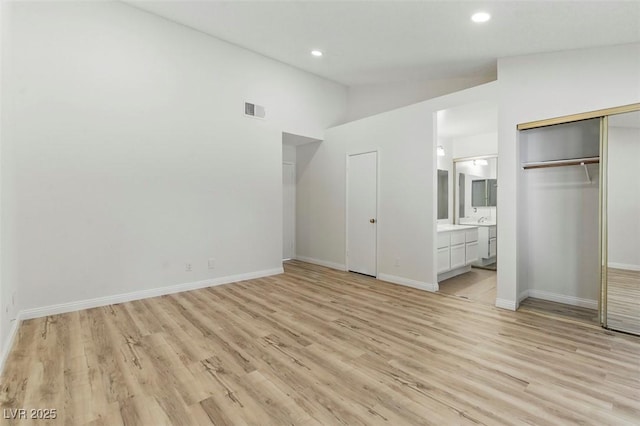 9116 Cypress Point Way, Las Vegas, NV 89117 - unfurnished bedroom with light wood-style floors, lofted ceiling, baseboards, ensuite bath, and recessed lighting