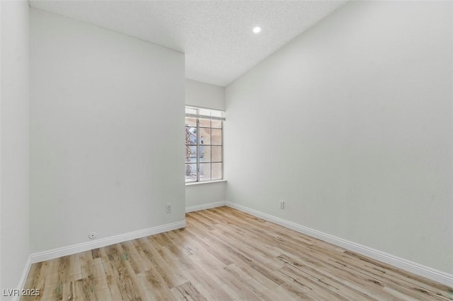 9116 Cypress Point Way, Las Vegas, NV 89117 - spare room featuring wood finished floors, baseboards, a textured ceiling, recessed lighting, and lofted ceiling