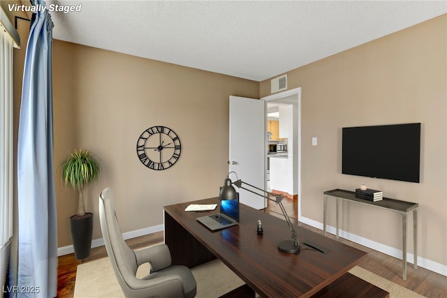 4391 Gannet Cir Unit 16, Las Vegas, NV 89103 - office area with wood finished floors, baseboards, and a textured ceiling