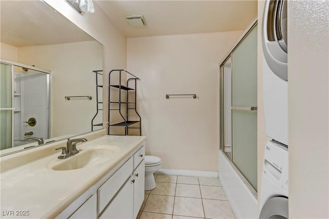 4391 Gannet Cir Unit 16, Las Vegas, NV 89103 - full bath with vanity, toilet, estacked washer and dryer, tile patterned flooring, and enclosed tub / shower combo