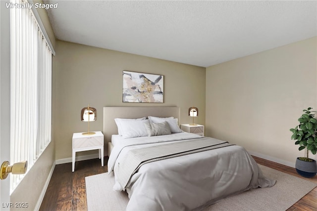 4391 Gannet Cir Unit 16, Las Vegas, NV 89103 - bedroom with dark wood finished floors, multiple windows, and baseboards