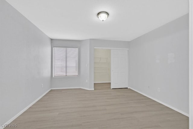 4400 W Lake Mead Blvd Unit 101, Las Vegas, NV 89108 - unfurnished bedroom with light wood-style floors, baseboards, and a closet
