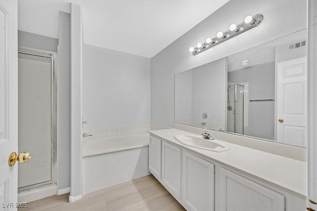 4400 W Lake Mead Blvd Unit 101, Las Vegas, NV 89108 - full bath with a shower stall, a garden tub, vanity, and wood finished floors