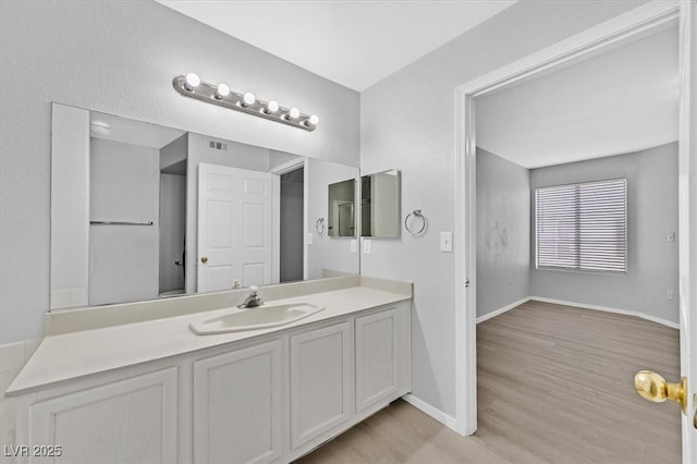 4400 W Lake Mead Blvd Unit 101, Las Vegas, NV 89108 - bathroom with vanity, wood finished floors, and baseboards