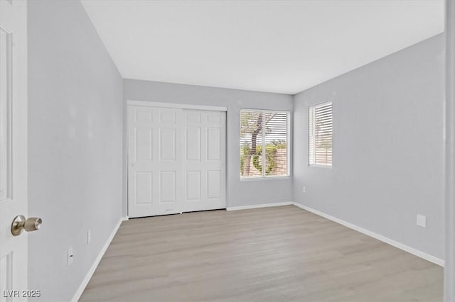 4400 W Lake Mead Blvd Unit 101, Las Vegas, NV 89108 - unfurnished bedroom featuring light wood-style floors, baseboards, and a closet
