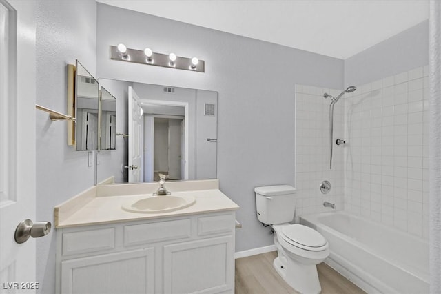 4400 W Lake Mead Blvd Unit 101, Las Vegas, NV 89108 - bathroom featuring toilet, wood finished floors, vanity, shower / bath combination with curtain, and baseboards