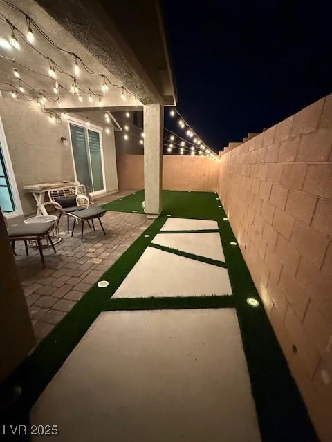 3447 SW Covilha Ln, Henderson, NV 89044 - patio at twilight featuring a fenced backyard and a patio area