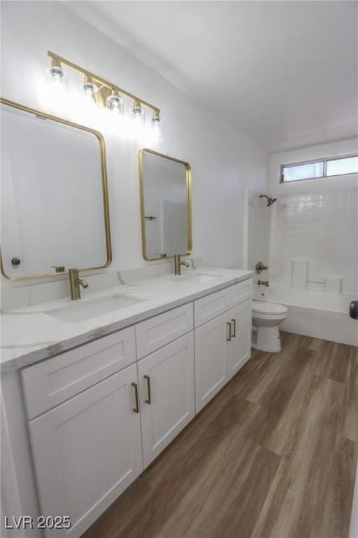 2711 Sesame Dr, Las Vegas, NV 89142 - bathroom featuring double vanity, bathing tub / shower combination, wood finished floors, and toilet