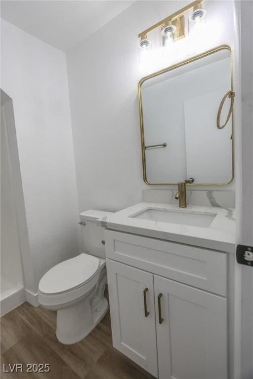 2711 Sesame Dr, Las Vegas, NV 89142 - bathroom with wood finished floors, vanity, toilet, and baseboards