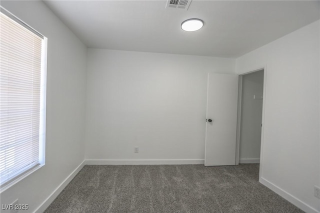 2711 Sesame Dr, Las Vegas, NV 89142 - spare room featuring dark carpet and baseboards