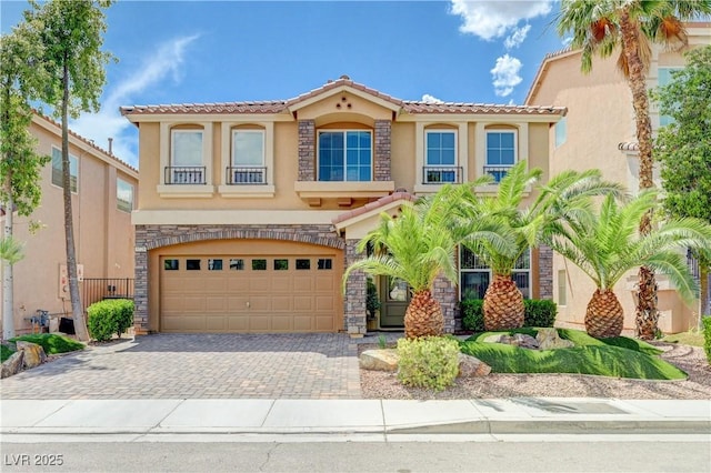 9729 Hawk Crest St, Las Vegas, NV 89141 - mediterranean / spanish home featuring a tiled roof, stucco siding, an attached garage, driveway, and stone siding