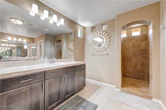9729 Hawk Crest St, Las Vegas, NV 89141 - bathroom featuring a walk in shower, baseboards, vanity, and tile patterned floors