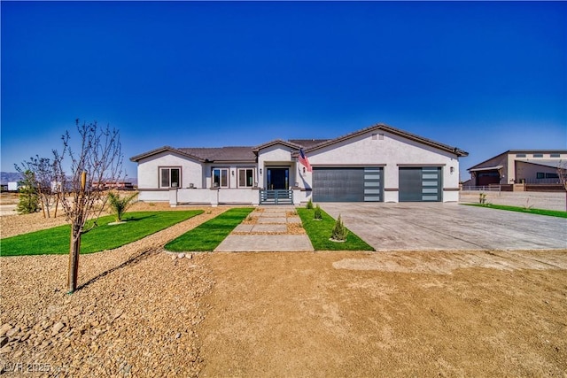 2650 Underbrush Ave, Pahrump, NV 89048 - single story home featuring a garage, driveway, stucco siding, and a front yard