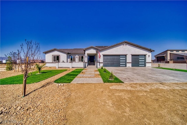 2650 Underbrush Ave, Pahrump, NV 89048 - single story home featuring an attached garage, driveway, stucco siding, and a front lawn