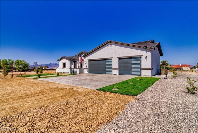 2650 Underbrush Ave, Pahrump, NV 89048 - ranch-style house with stucco siding, an attached garage, and concrete driveway