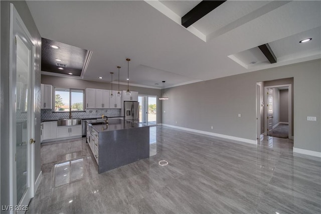 2650 Underbrush Ave, Pahrump, NV 89048 - kitchen with stainless steel refrigerator with ice dispenser, dark countertops, tasteful backsplash, white cabinets, and a kitchen island