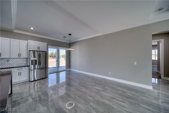 2650 Underbrush Ave, Pahrump, NV 89048 - kitchen featuring stainless steel fridge with ice dispenser, decorative backsplash, decorative light fixtures, ornamental molding, and dark countertops
