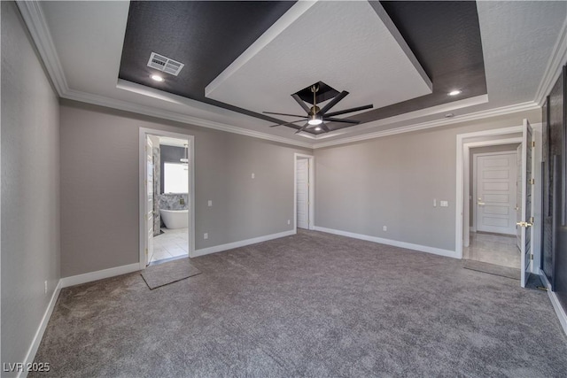2650 Underbrush Ave, Pahrump, NV 89048 - unfurnished bedroom featuring a tray ceiling, carpet, crown molding, ensuite bathroom, and a ceiling fan