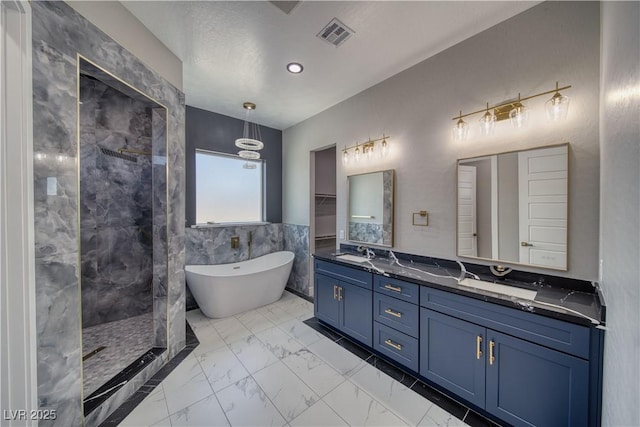 2650 Underbrush Ave, Pahrump, NV 89048 - full bath featuring marble look tile flooring, a freestanding bath, double vanity, and walk in shower