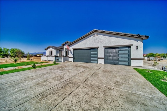 2650 Underbrush Ave, Pahrump, NV 89048 - single story home with concrete driveway, a garage, stucco siding, and a tile roof