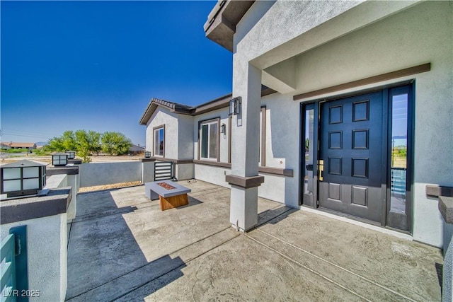 2650 Underbrush Ave, Pahrump, NV 89048 - doorway to property with stucco siding and a patio area