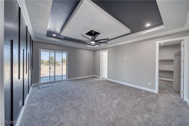 2650 Underbrush Ave, Pahrump, NV 89048 - unfurnished bedroom with a tray ceiling, carpet floors, ornamental molding, access to outside, and a walk in closet