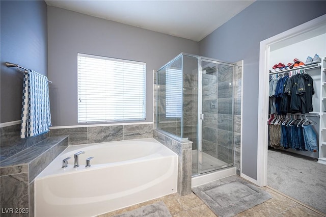 6333 Sterling Ranch Way N, Las Vegas, NV 89081 - full bathroom with a bath, a stall shower, a walk in closet, and baseboards