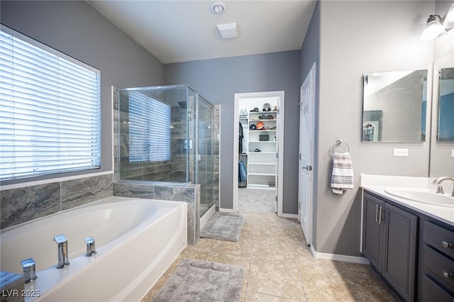 6333 Sterling Ranch Way N, Las Vegas, NV 89081 - bathroom featuring a stall shower, a bath, vanity, a spacious closet, and baseboards