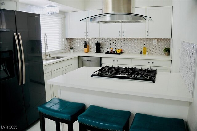 2659 Vegas Valley Dr, Las Vegas, NV 89121 - kitchen featuring black fridge with ice dispenser, wall chimney exhaust hood, gas stovetop, stainless steel dishwasher, and a sink
