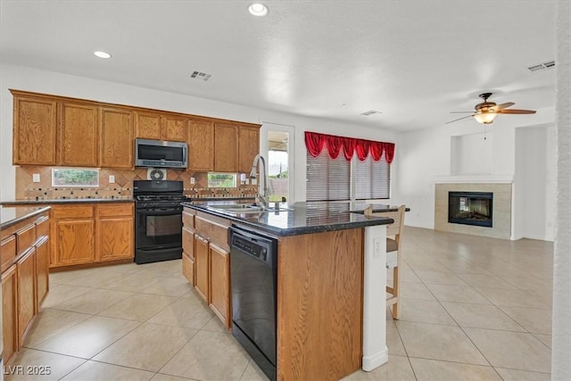 3689 Bufflehead St, Las Vegas, NV 89122 - kitchen featuring stainless steel microwave, gas range oven, dishwasher, a sink, and light tile patterned floors