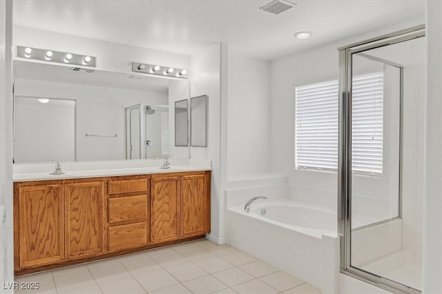 3689 Bufflehead St, Las Vegas, NV 89122 - full bathroom with a garden tub, a stall shower, and double vanity