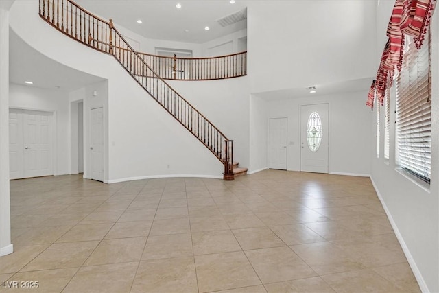 3689 Bufflehead St, Las Vegas, NV 89122 - foyer entrance with a high ceiling, light tile patterned floors, stairs, baseboards, and recessed lighting
