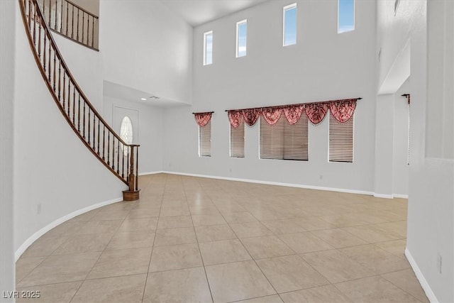 3689 Bufflehead St, Las Vegas, NV 89122 - entryway featuring a towering ceiling, light tile patterned floors, stairs, and baseboards