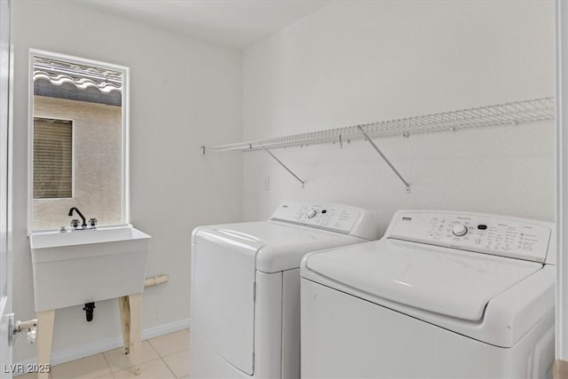 3689 Bufflehead St, Las Vegas, NV 89122 - laundry room featuring washer and clothes dryer, baseboards, and light tile patterned floors