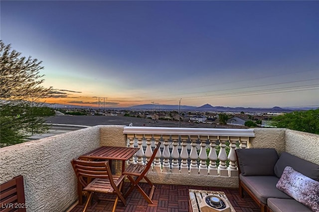 672 Solitude Point Ave, Henderson, NV 89012 - balcony at dusk featuring an outdoor living space