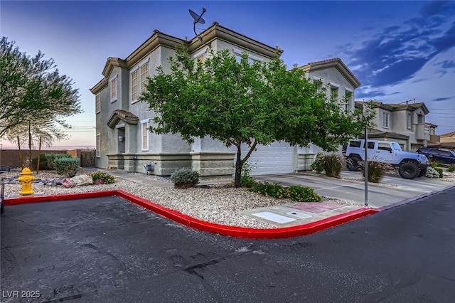 672 Solitude Point Ave, Henderson, NV 89012 - view of front facade with stucco siding and a garage