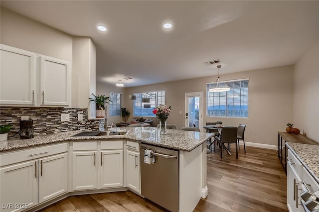 672 Solitude Point Ave, Henderson, NV 89012 - kitchen featuring stainless steel dishwasher, a peninsula, a sink, white cabinetry, and recessed lighting