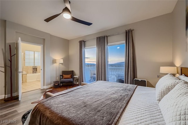 672 Solitude Point Ave, Henderson, NV 89012 - bedroom with wood finished floors, baseboards, ceiling fan, and ensuite bathroom