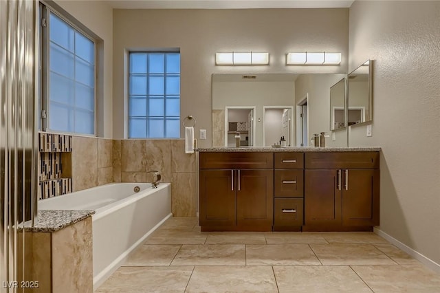 672 Solitude Point Ave, Henderson, NV 89012 - bathroom featuring double vanity, a garden tub, and tile patterned flooring