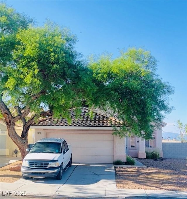 7528 Golden Yucca Dr, Las Vegas, NV 89147 - view of front of house with an attached garage, driveway, a tile roof, and stucco siding