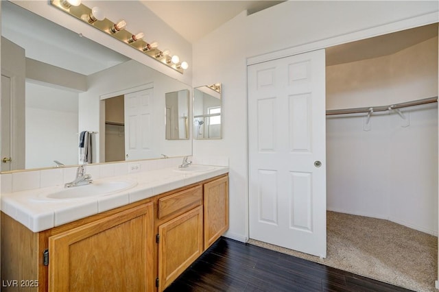 7528 Golden Yucca Dr, Las Vegas, NV 89147 - full bathroom with double vanity, a spacious closet, and wood finished floors