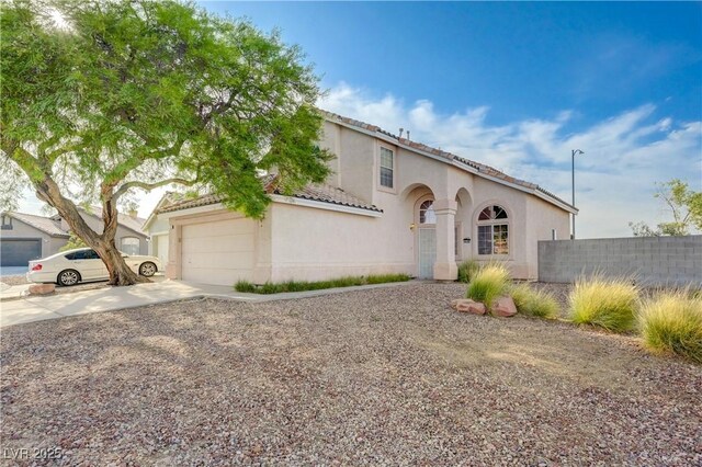 7528 Golden Yucca Dr, Las Vegas, NV 89147 - mediterranean / spanish-style house featuring driveway, stucco siding, a garage, and a tile roof