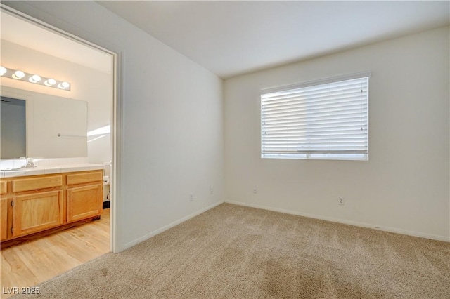 7528 Golden Yucca Dr, Las Vegas, NV 89147 - unfurnished bedroom featuring light colored carpet and connected bathroom