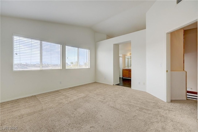 7528 Golden Yucca Dr, Las Vegas, NV 89147 - unfurnished bedroom with carpet flooring, lofted ceiling, and ensuite bath