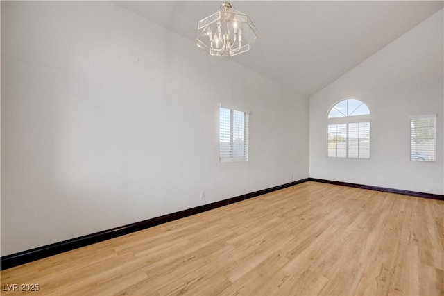 7528 Golden Yucca Dr, Las Vegas, NV 89147 - empty room featuring high vaulted ceiling, a chandelier, and light wood-style floors