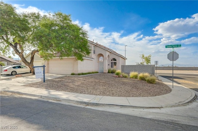 7528 Golden Yucca Dr, Las Vegas, NV 89147 - view of front of home with stucco siding, an attached garage, and driveway